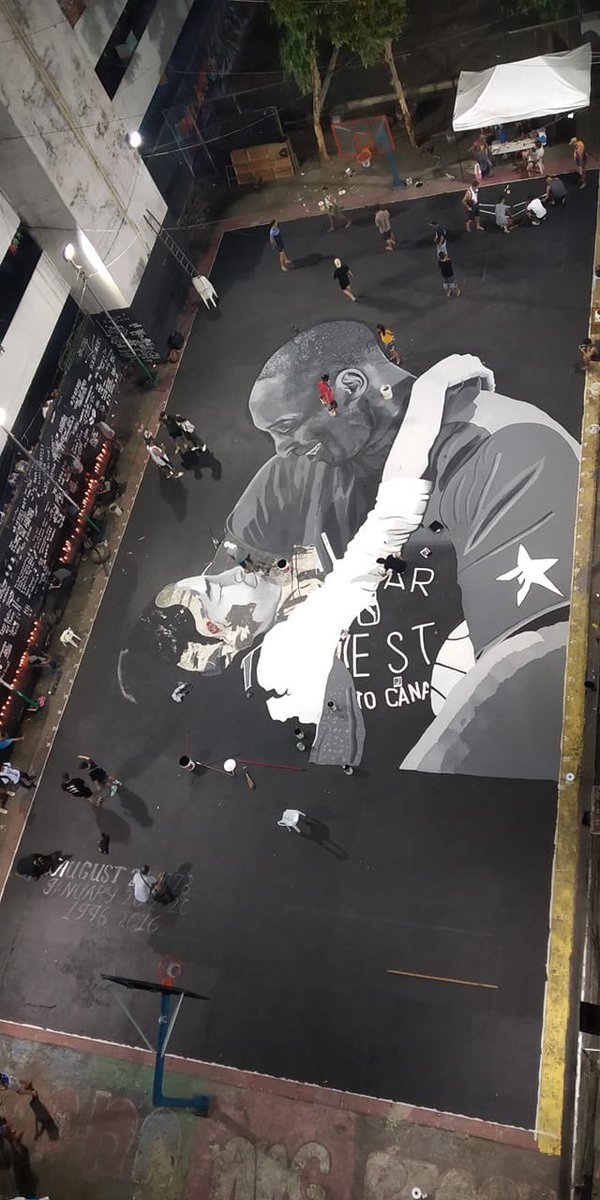 W_Drehs's tweet image. The pain of Kobe’s death is without borders. This is the famed Tenement basketball court in Manila today, where work is still ongoing on a tribute mural. The hand-painted court is surrounded by candles and personal tributes. Amazing work by  @IamMikeSwift and his team.