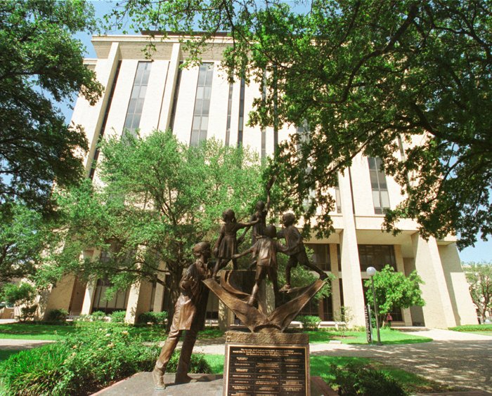 Old photo of the exterior of Harrington with sculpture in focus