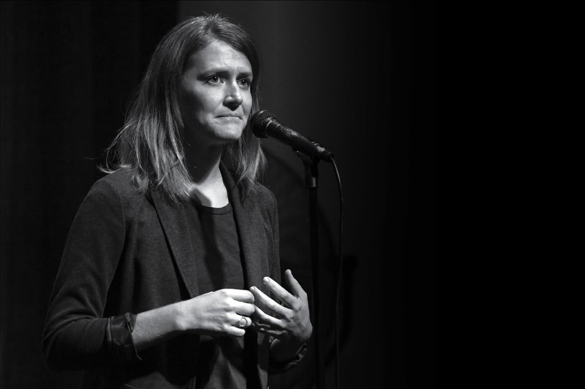 Photo of Catherine Macdonald telling her story at the microphone