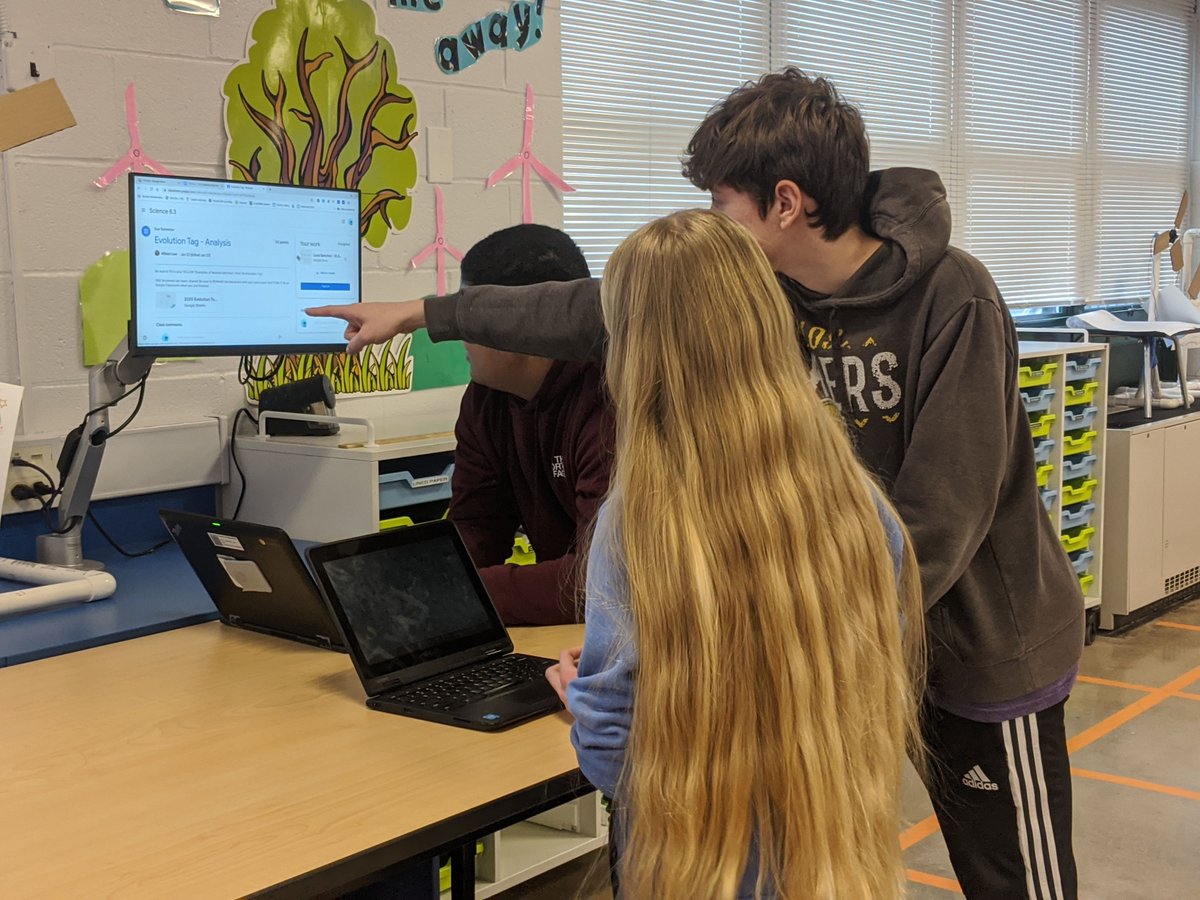 8th graders collaborating on they're reflections from an  evolution tag game