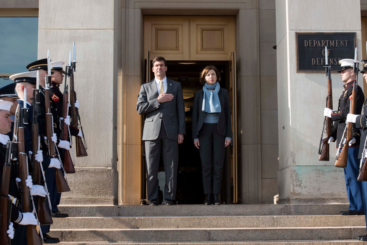 Secretary Esper, with his right hand over his heart, stands next to the French Minister of the Armed Forces during an outdoor honor cordon ceremony at the Pentagon.