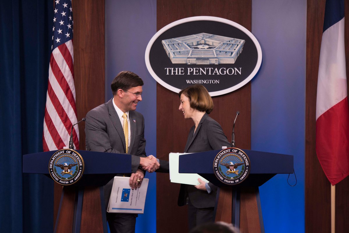 Secretary Esper and French Minister of the Armed Force Florence Parly shake hands as they stand at the lecterns in the Pentagon briefing room. 
