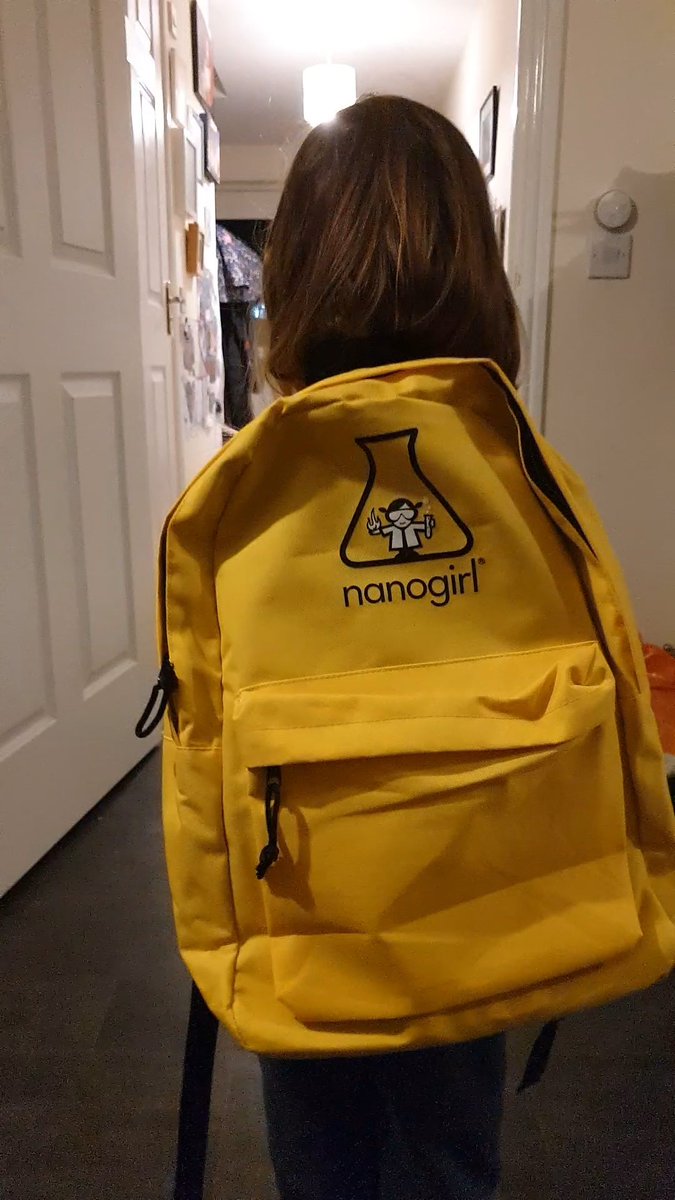 Yellow nanogirl live rucksack on the back of a little girl facing away from the camera