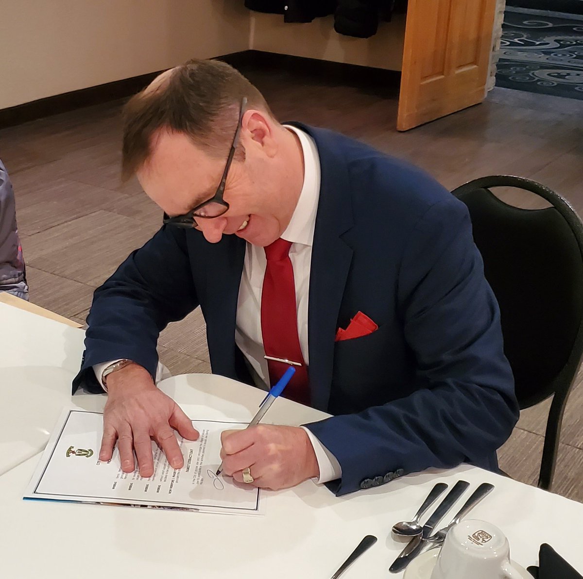 Mayor Fraser Tolmie signing a  proclamation for the Day of Literacy.