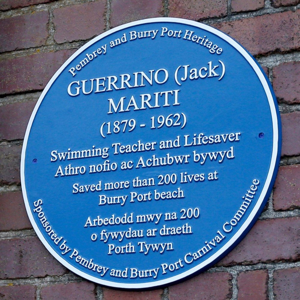 llanellionline's tweet photo. The Burry Port Carnival Committee have sponsored a Blue Plaque in Burry Port to remember a local hero Guerrino 'Jack' Mariti a teacher and swimming instructor who saved over 200 lives.  #burryport #carnivalcommittee #guerrinojackmariti #lifesaver #lifeboa https://t.co/sGj6AuIis4 https://t.co/ZRS66ExM0d