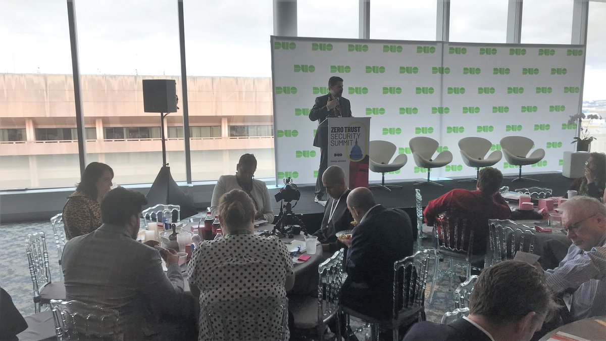 Bill Z speaking at the event, onstage in front of crowd