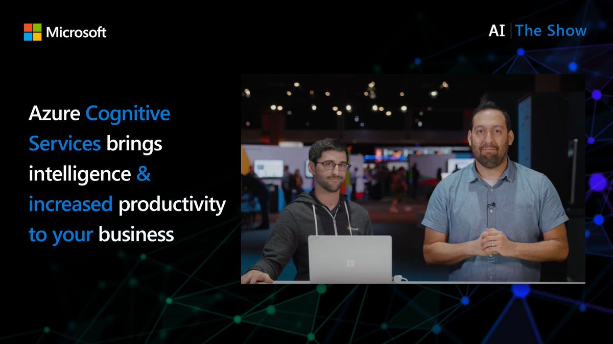 Two presenters in front of a laptop. 