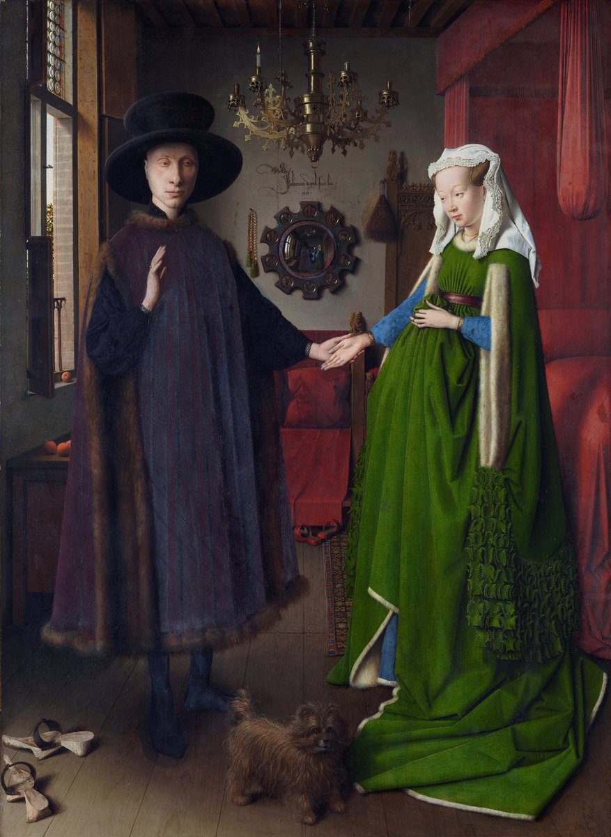 Ma non vedete un filo conduttore tra la foto che annuncia l’arrivo di Karnezis ed il Ritratto dei coniugi Arnolfoni di Van Eyck?Così come nello specchio del dipinto, anche la realtà che si riflette nel televisore è totalmente difforme da quello che vediamo in primo piano.