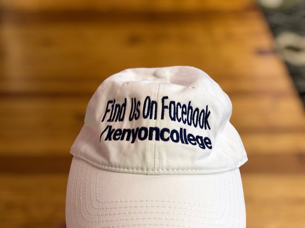 A white baseball cap with text “Find us on Facebook /kenyoncollege”