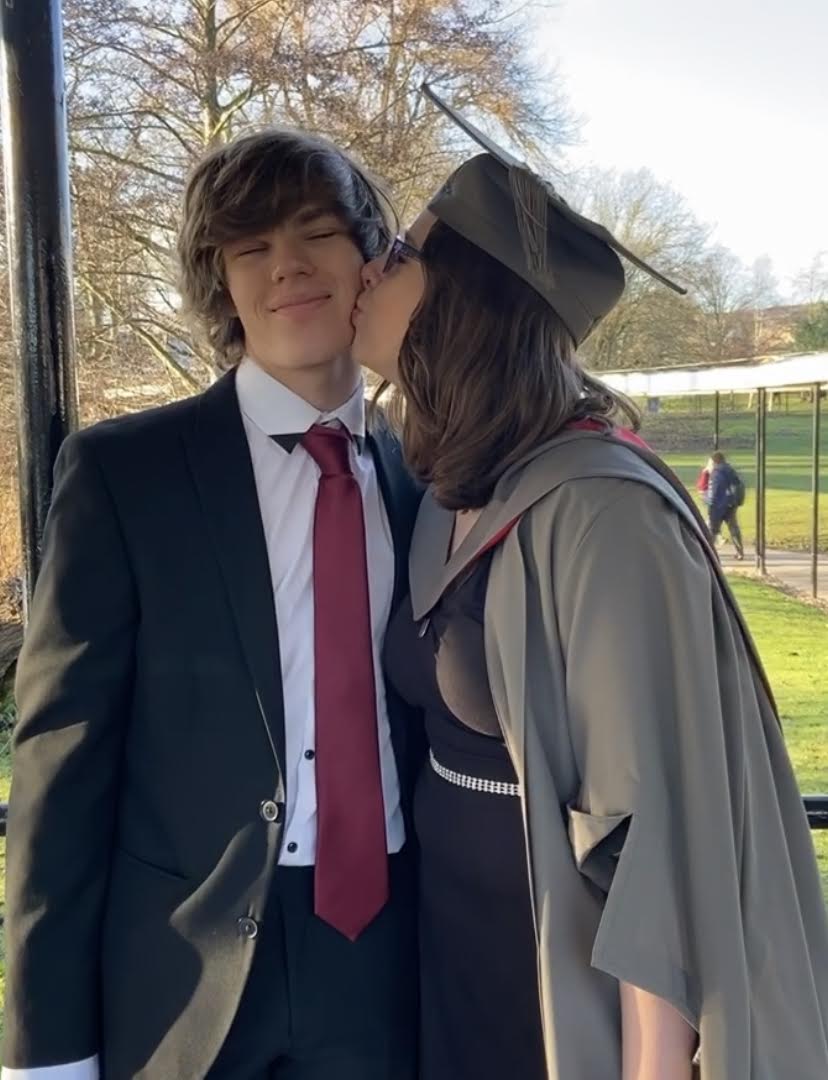 Rach in her gown kissing me, wearing a suit