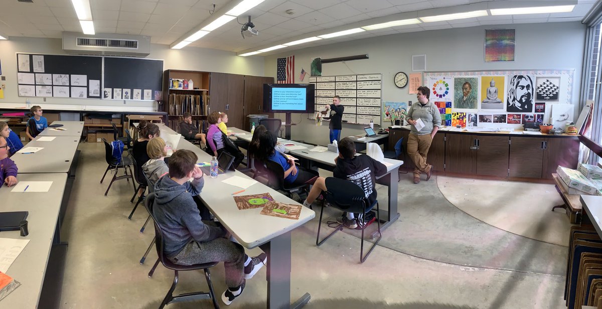WahooHSARt's tweet photo. 6th Grade artist sharing their portrait creations with their peers.  Answering prompts on the screen to help guide the process.  Nice job reflecting on your work today!  #ExcellenceEverywhere ⁦@HooOnTheGo⁩ ⁦@wahoopublic⁩ https://t.co/nsvEAF7cyx