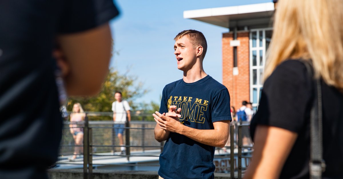 A student giving a tour of campus. 