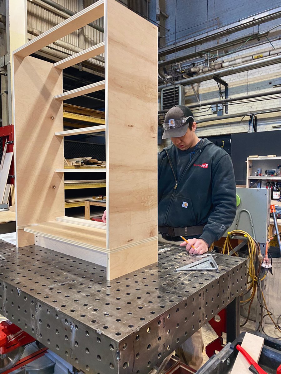 Make fabricator looking at his partially built bureau. Oak plywood material.