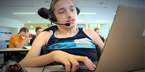 Student in a wheelchair uses a computer