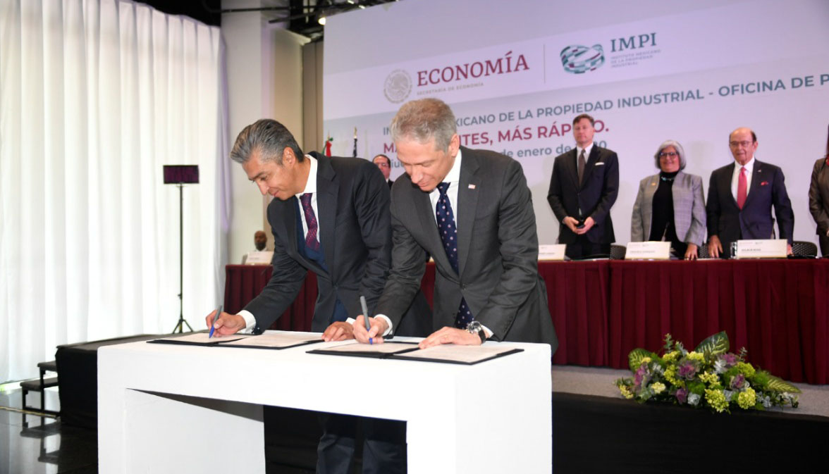 two men signing agreements