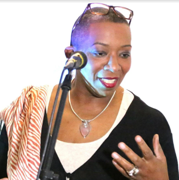 Shirley May in front of a microphone