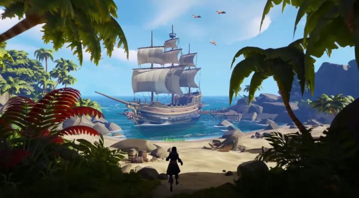 Screenshot of Sea of Thieves shoiwng a pirate on a beach with a large ship just off shore