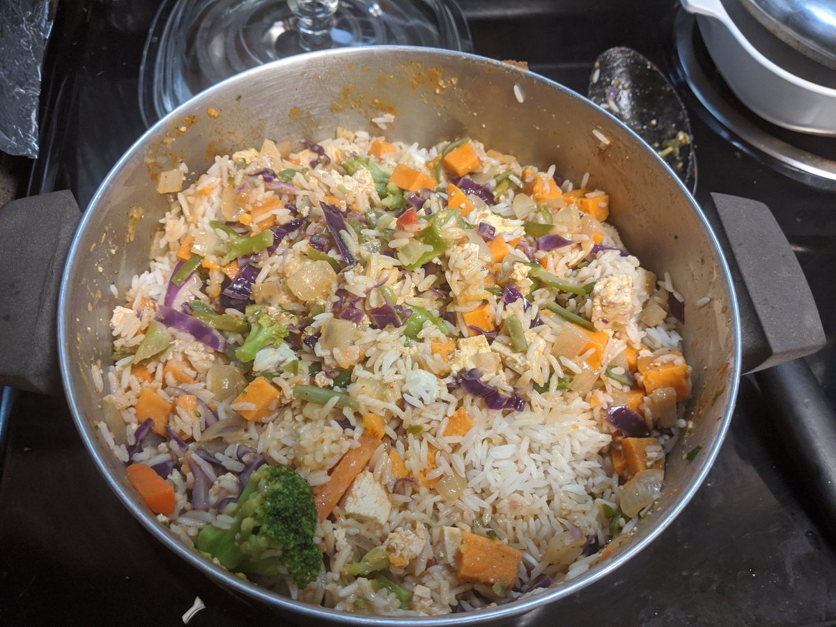 Nearly full pot of sweet potato curry with rice mixed in. The rice is still dried out from sitting in the fridge.