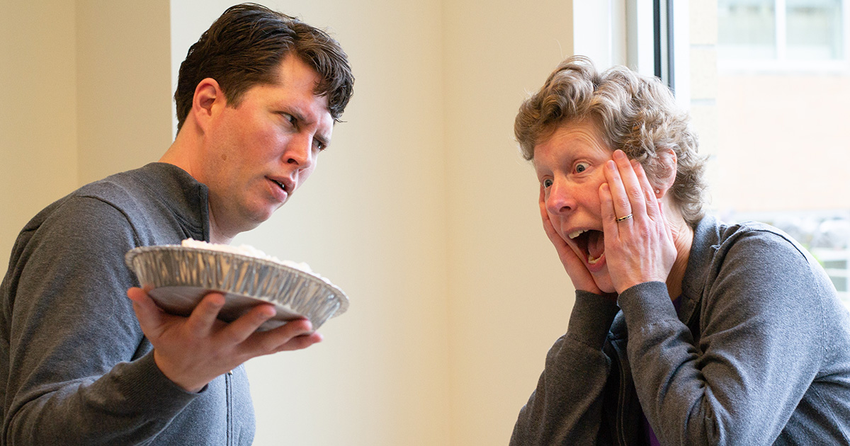 Joe Eckert holds a pie menacingly near Helene Williams.