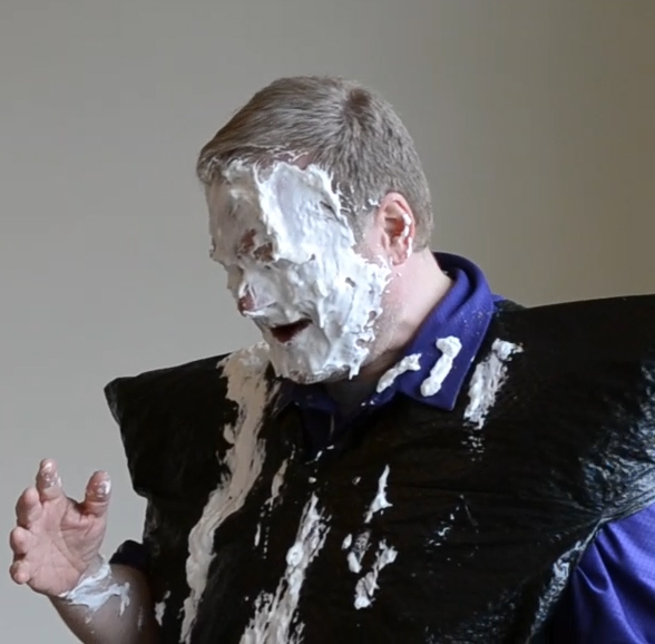 Scott Barker is coated in pie.