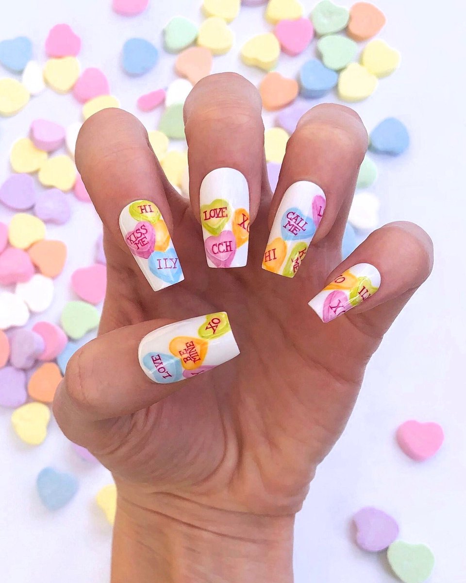 Conversation heart nails, with a certain sweetheart’s initials hidden in there 🍬 #nailedbyceline