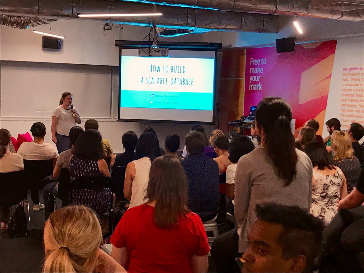 Sasha speaking in front of a room of women who code