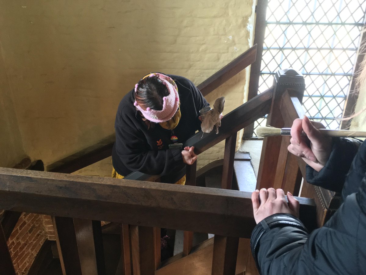 Two volunteers washing & waxing the Castle Guardhouse stair bannister