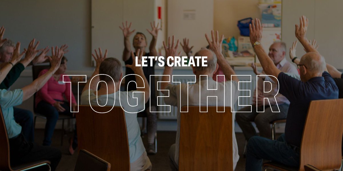 A group of older people are sitting in circle holding their arms above their heads. The image has text across it. It reads Let's Create Together.