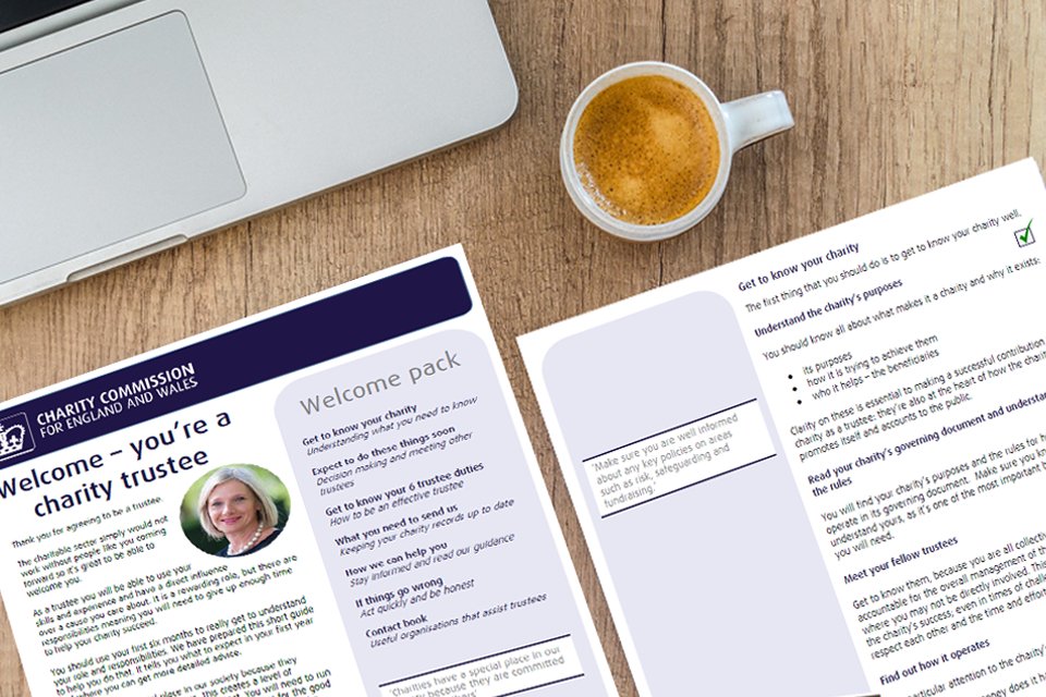 Print outs of our welcome pack on a desk next to a hot drink.