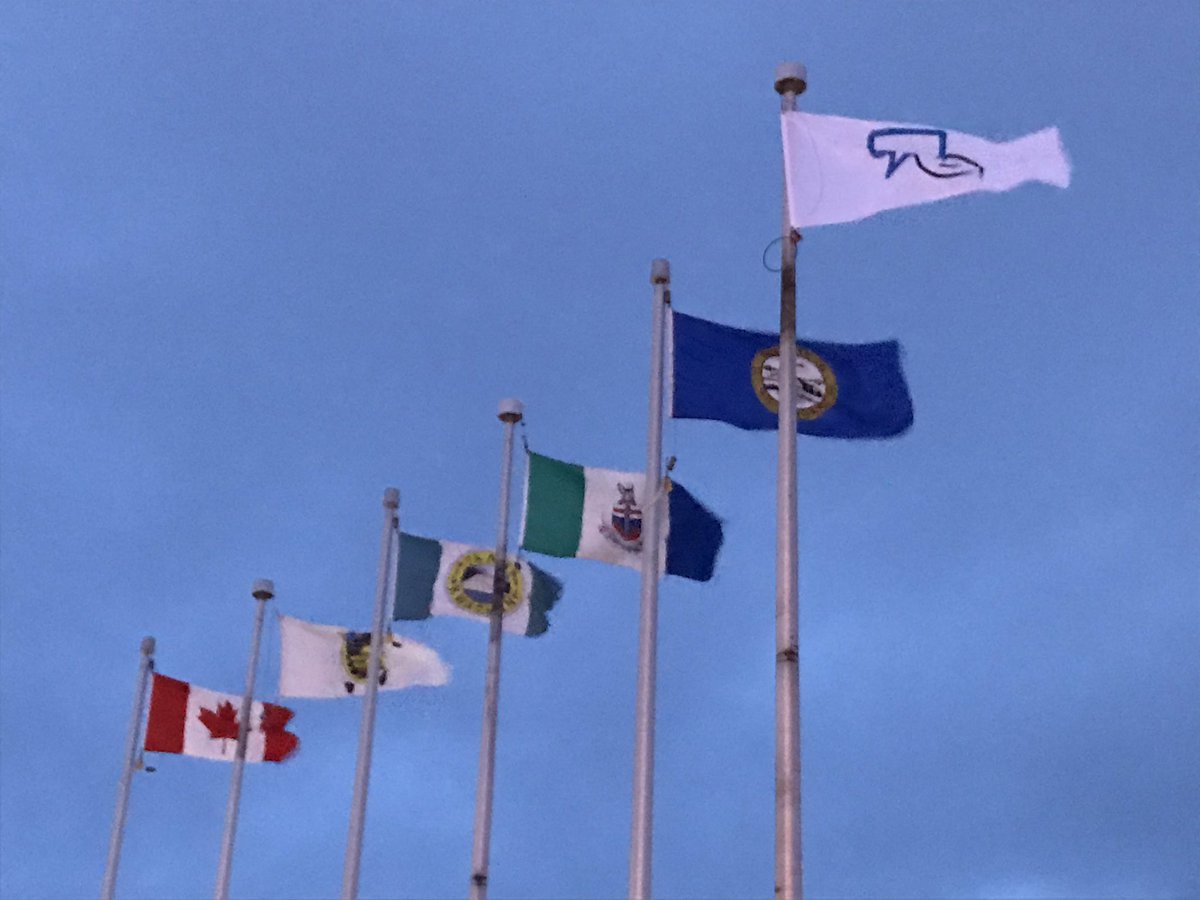 yukoncollege's tweet photo. Students and staff gather to cheer the #BellLetsTalk flag raising at Ayamdigut today! Important message from student Paige Savard - we are all mental health advocates and every action we take to support  others counts. https://t.co/w6CVGl3KMV