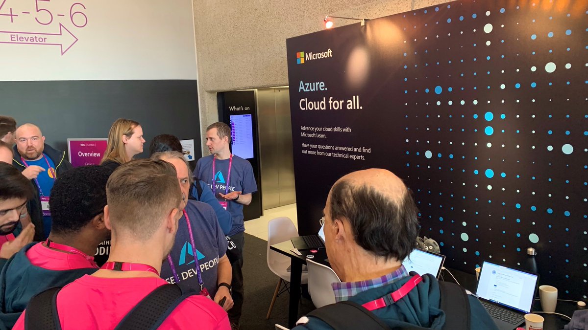 Image of the Microsoft stand at the National Developer Conference, microsoft representatives are answering questions. 