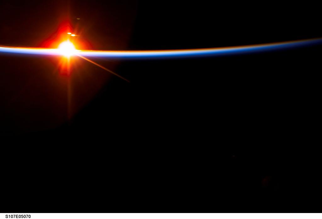 The bright sun dissects the airglow above Earth's horizon in this digital still camera's view photographed from the Space Shuttle Columbia.