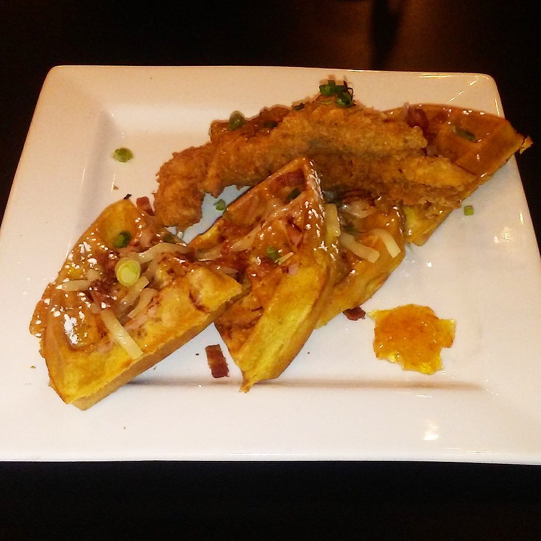 CHICKEN CORDON BLUE WAFFLE — a smoked ham waffle tolled with Swiss cheese and bacon crumbles served with a country fried chicken tenderloin and finished with an orange marmalade $8.99