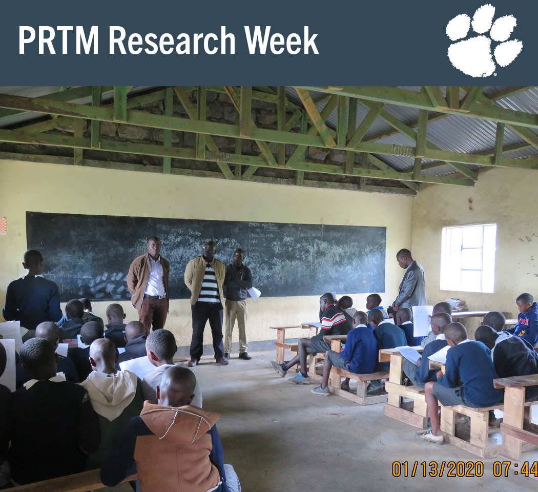 Researchers talking to students in a classroom in a community in Kenya.