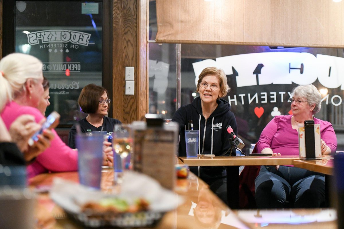 Elizabeth sitting with volunteers.