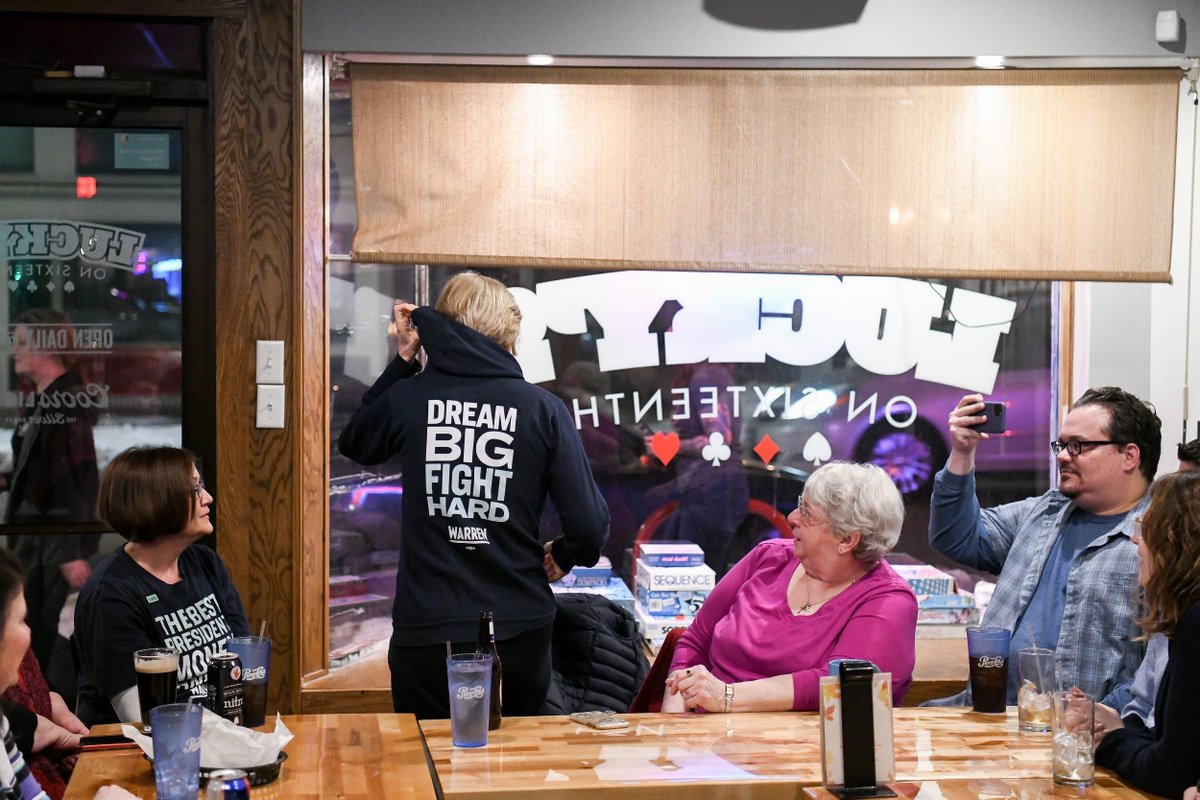 Elizabeth stands to show everyone her hoodie that says, "Dream Big, Fight Hard."