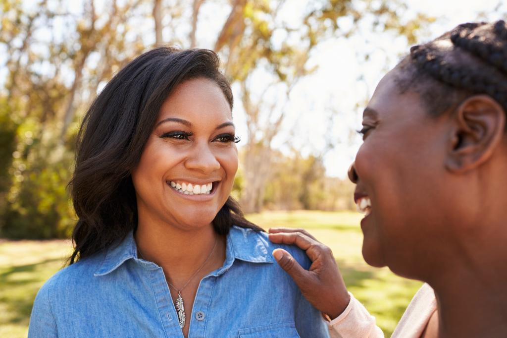 Mother And Adult Daughter Talking In Park Together, Talking, Women, African-American Ethnicity, Only Women, Mother