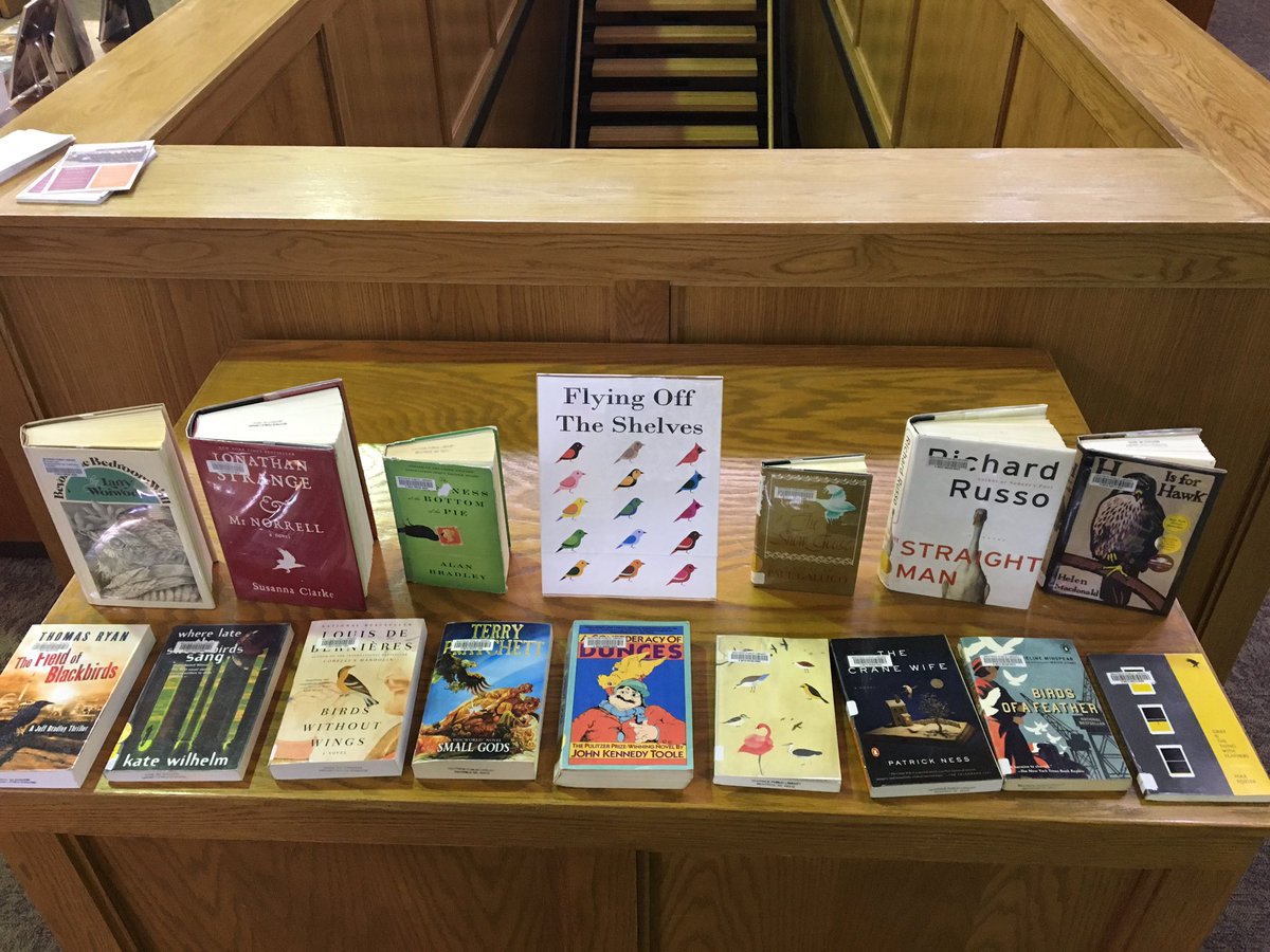 A display of books with birds on the cover. There is a sign that reads “Flying Off The Shelves”