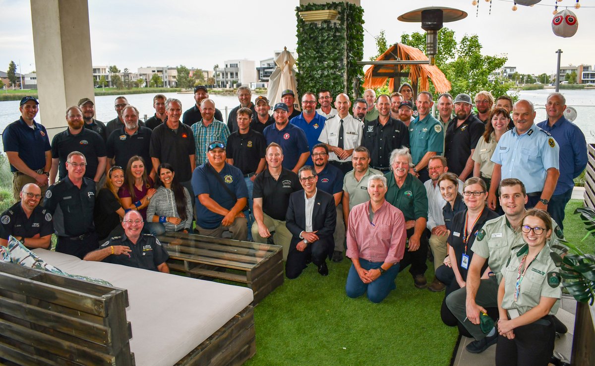 Dozens of people lined up in three rows having their picture taken.