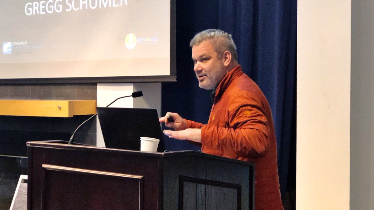 A man speaks into a microphone at a podium.