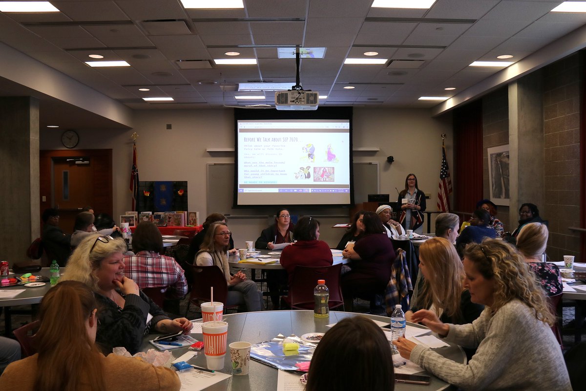 A room full of people watching a power point presentation.