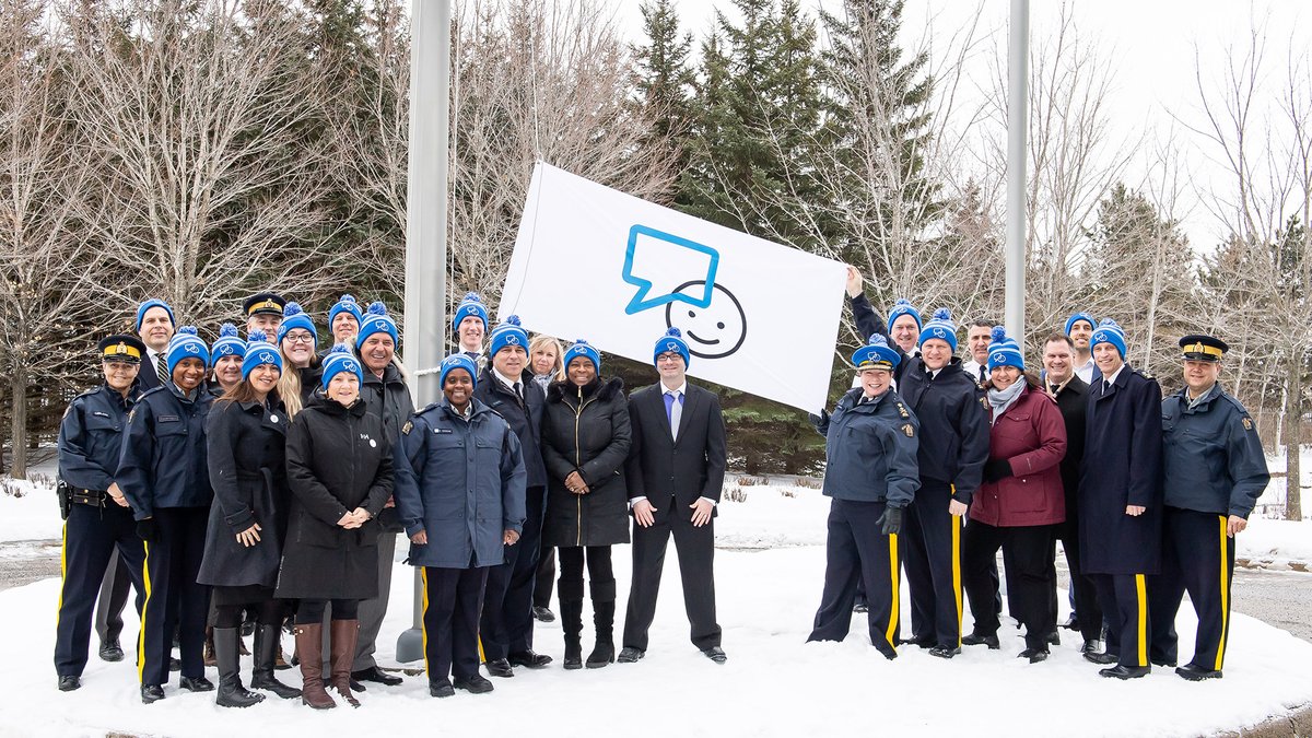 Commissioner Lucki, senior executives, and other RCMP employees raising the Bell Let's Talk Day flag at National Headquarters in Ottawa.