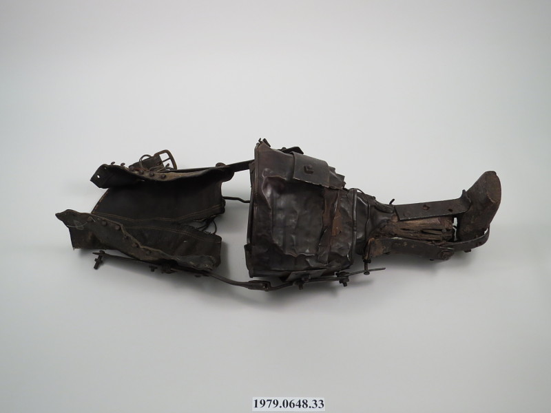 The color photograph shows a dark coloured prosthetic lying on its side