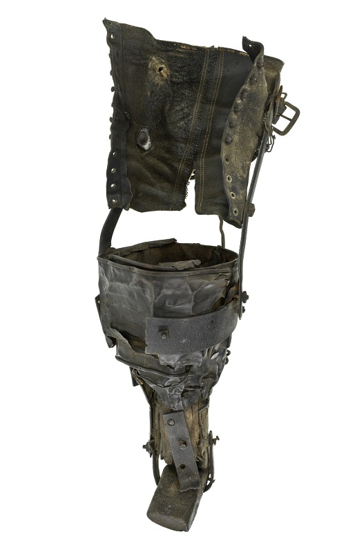 The color photograph shows a dark coloured prosthetic on its side