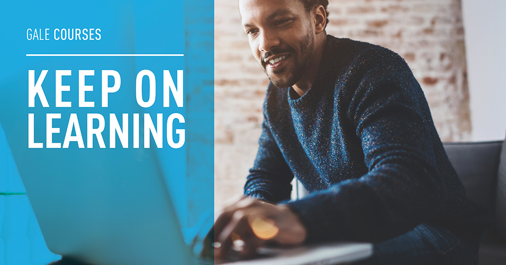 a man looking at his laptop screen smiling