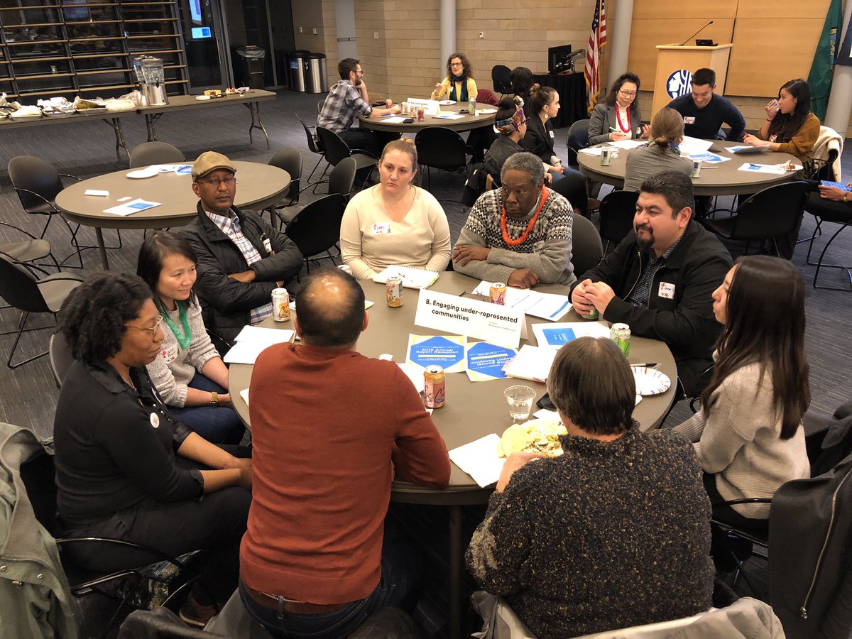 Large group of people having a discussion at a round table