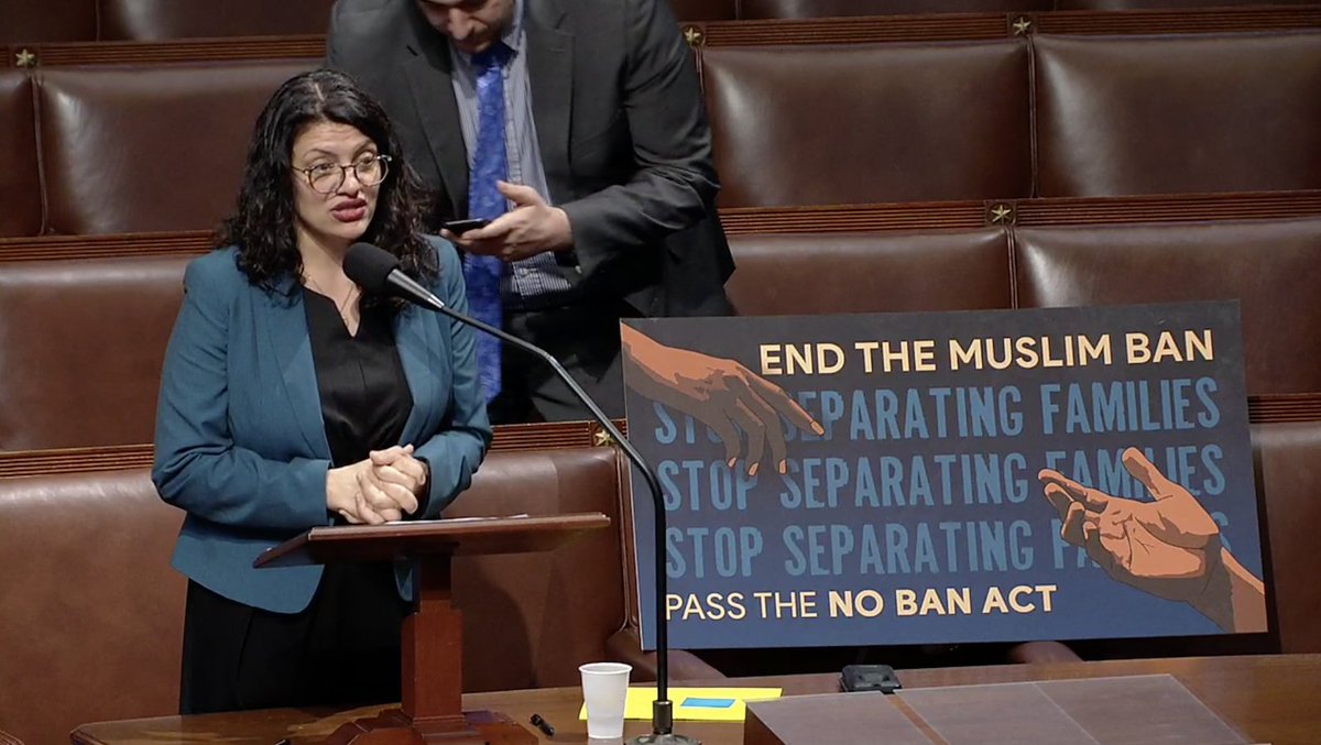Rep. Rashida Tlaib speaks on the House floor with a poster that says "End the Muslim ban. Stop separating families. Pass the No Ban Act."