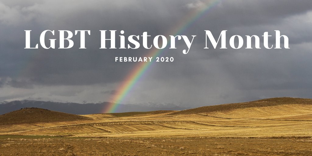 a rainbow arcs across a grey sky into a mustard coloured plain.