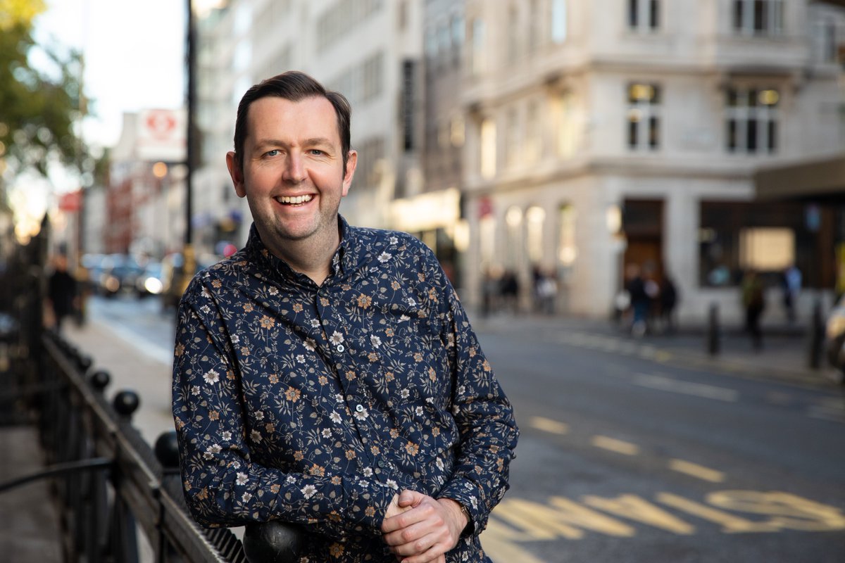 Alan leading on a balustrade outside the Library and Heritage Centre near Oxford Circus