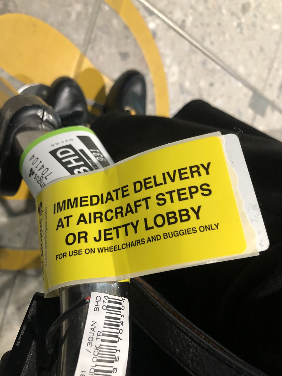Yellow label on Tracey wheelchair. It say “Immediate delivery to the aircraft steps”.
